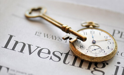 key and pocket watch on newspaper
